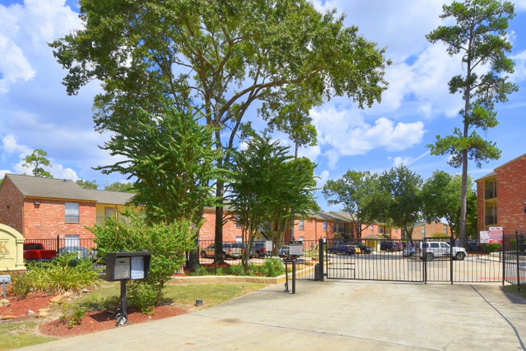 Entrance gate into the parking lot and complex at the Park at Deerbrook Apartments.