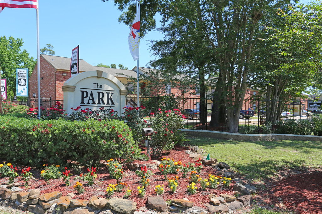 View of the entrance sign of The Park at Deerbrook Apartments.